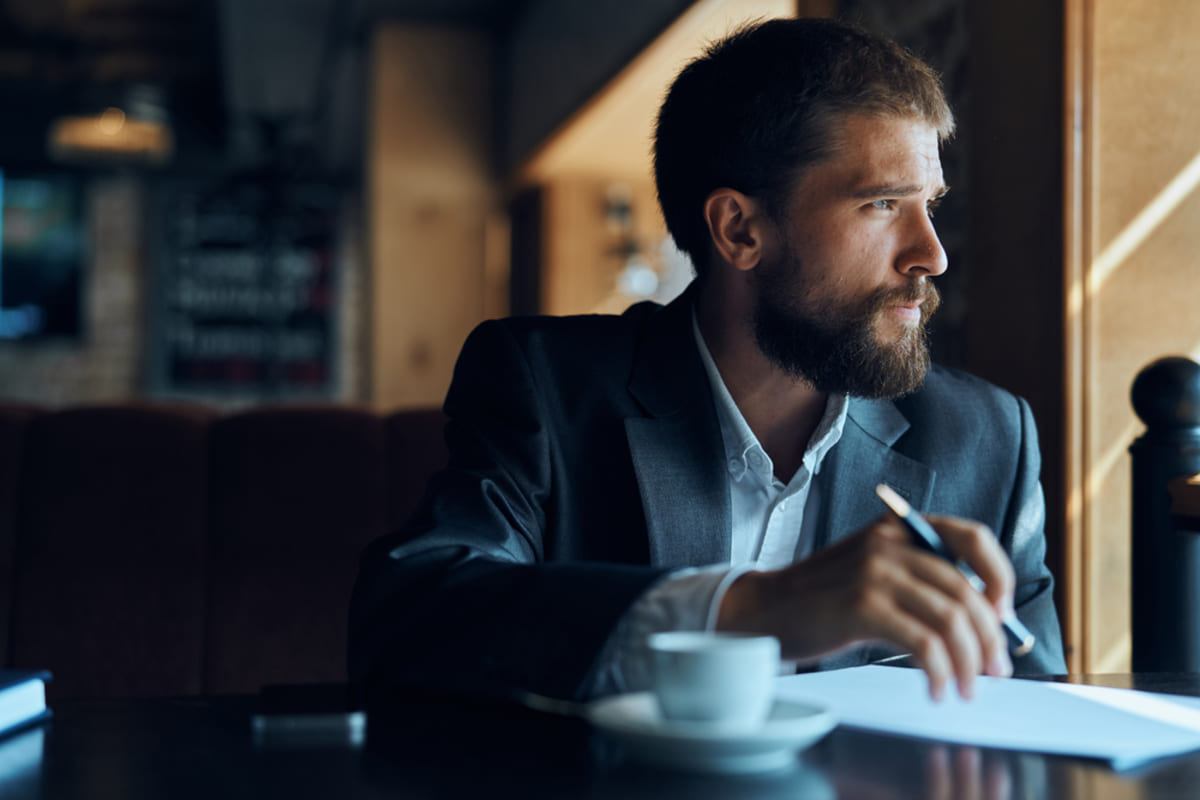 A businessman looking out the window and thinking about profit first for real estate investing concept