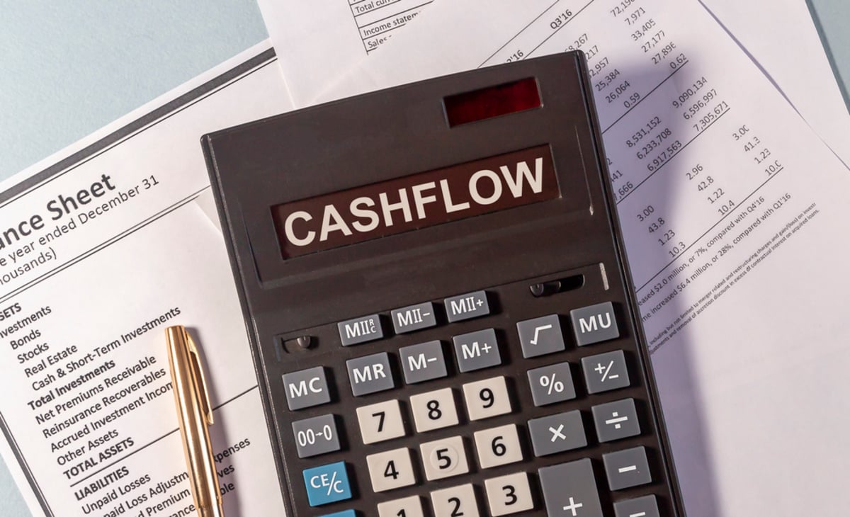 A calculator that says cash flow on top of accounting documents